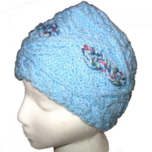 Child's blue hand knit hat with multi-color cable